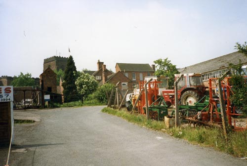 Burgess rear yard showing agricultural implements and smoke tower.